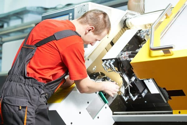Centerless Plunge and Through Grinding, mechanical worker of cnc grinding cutting machine at tool workshop manufacturing
